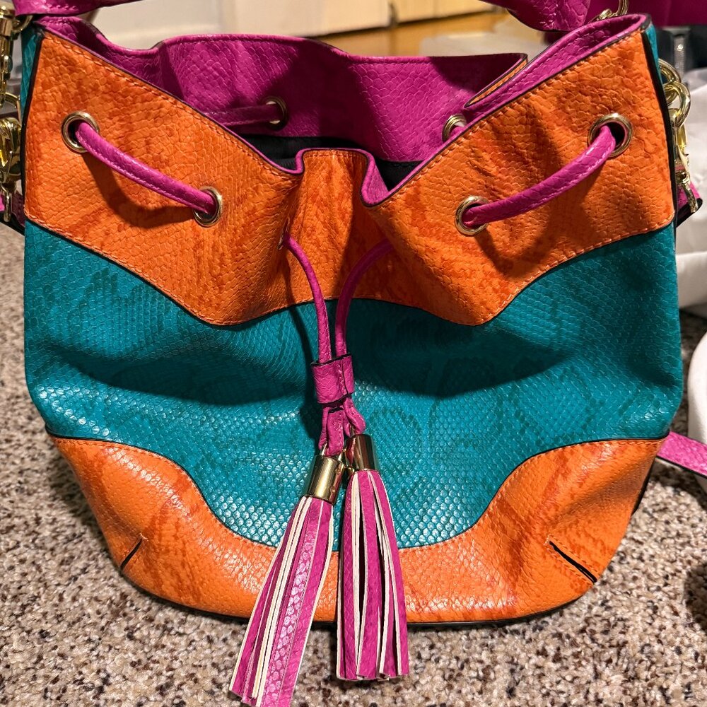 Color-block textured leather drawstring bucket bag with tassels by Aldo